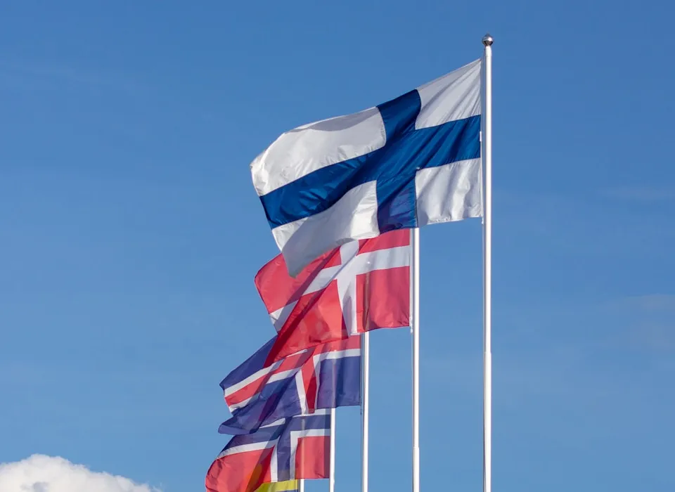 white red and blue striped flag under blue sky during daytime