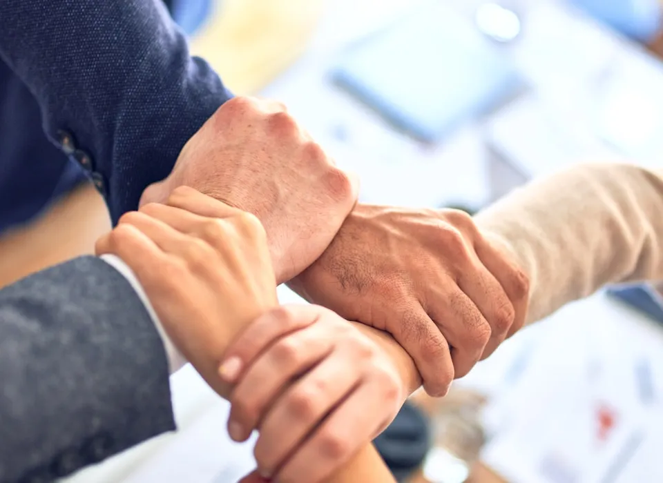 person in black long sleeve shirt holding persons hand
