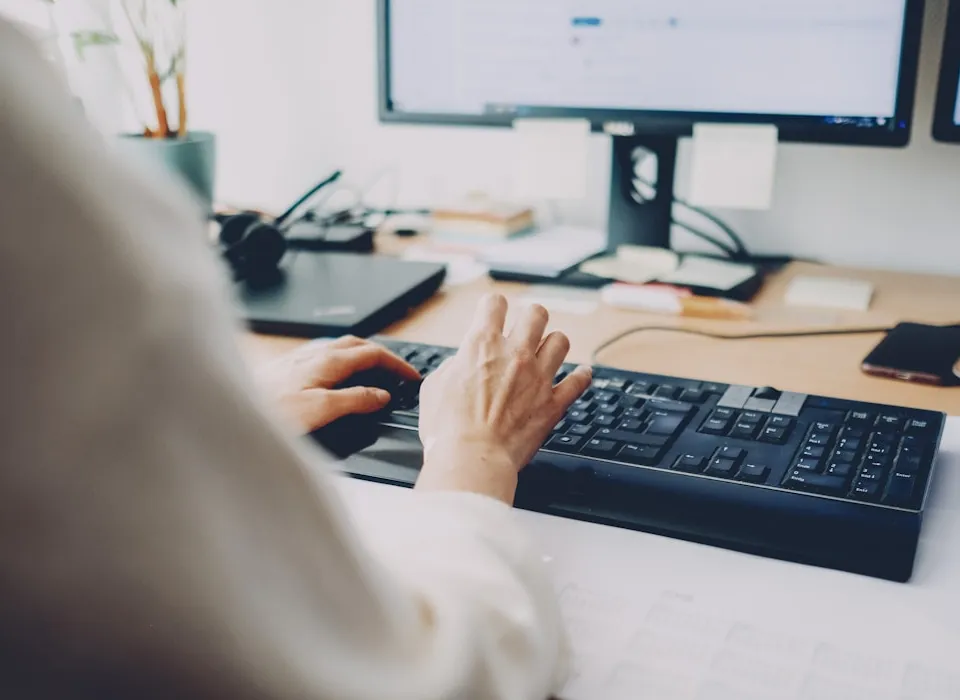 a person is typing on a computer keyboard